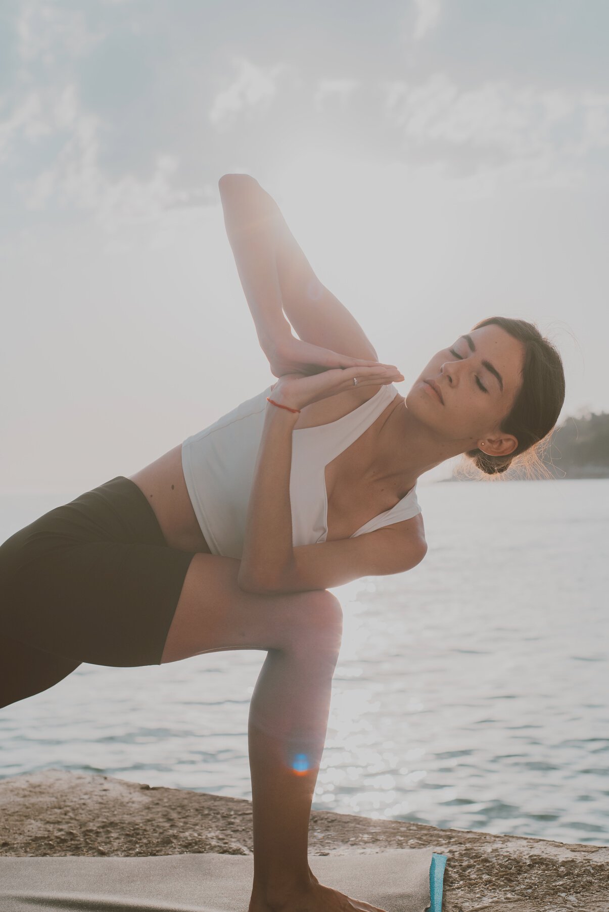 A Woman Doing Yoga on the Beach